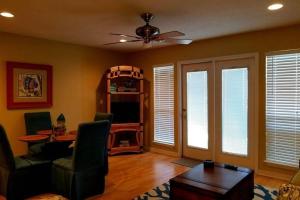 a living room with a couch and a ceiling fan at Grand Caribbean in Pensacola