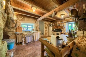 a large kitchen with wooden walls and wooden ceilings at HERITAGE Villa DEA RUSTICA in Malinska