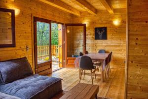 a living room with a table and a couch at Le chalet de Magali in Briançonnet