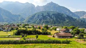 a small village in a valley with mountains in the background at Agritur Airone Bed & Camping in Levico Terme