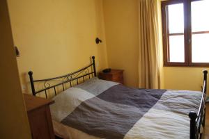 a bedroom with a bed and a window at Maison de charme près de la mer in Bormes-les-Mimosas