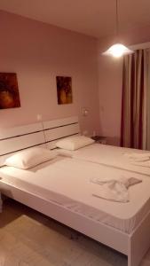a large white bed in a room at Mare Monte in Ios Chora