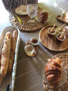 a table with several plates of bread and drinks at La Ferme de Gringalet in Anthon +19 photos