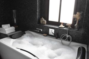 a bathroom with a bath tub with clouds in it at Home Apartments Jerez in Jerez de la Frontera