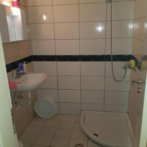 a bathroom with a sink and a shower and a toilet at studio room in Koropi