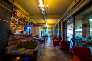 a restaurant with chairs and tables and a bar at Casa Budulan in Drobeta-Turnu Severin