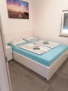 a bed in a room with avertisement for at Holiday Park Mimoza in Bašanija