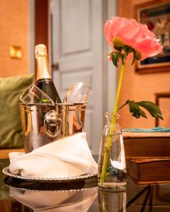 a bottle of champagne and a flower in a vase at Victory Hotel in Stockholm