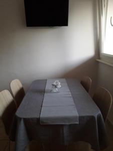 a dining room table with a blue table cloth on it at Apartments Natalija & Ante in Grebaštica