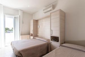 Postel nebo postele na pokoji v ubytování Hotel Primiana