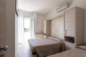 Postel nebo postele na pokoji v ubytování Hotel Primiana