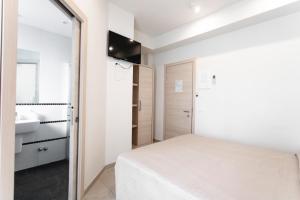 Postel nebo postele na pokoji v ubytování Hotel Primiana