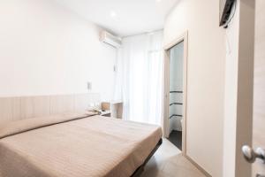 Postel nebo postele na pokoji v ubytování Hotel Primiana