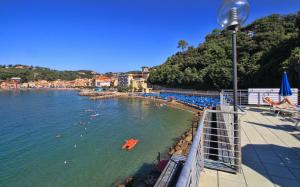 a group of people in the water at a beach at Hotel San Terenzo in Lerici