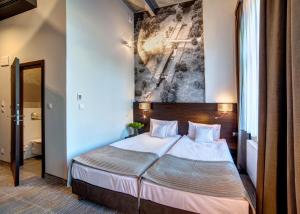 Łóżko lub łóżka w pokoju w obiekcie Hotel Loft 1898