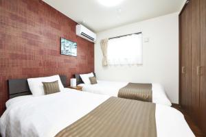 Postel nebo postele na pokoji v ubytování E-horizon Resort コンドミニアム名護D