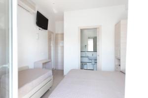 Postel nebo postele na pokoji v ubytování Hotel Primiana