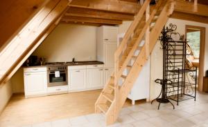 a kitchen with a wooden staircase in a house at Landhotel Untere Mühle in Straßberg