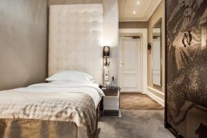 Postel nebo postele na pokoji v ubytování Elite Plaza Hotel