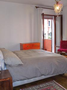 a bedroom with a bed and a dresser and a window at Cà Dolce in Venice