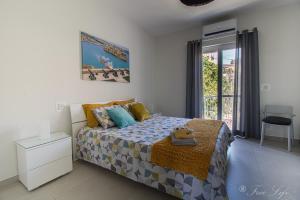 a bedroom with a bed and a window at Mgarr Waterfront Cosy Apartment 3 by Ghajnsielem Gozo in Mġarr