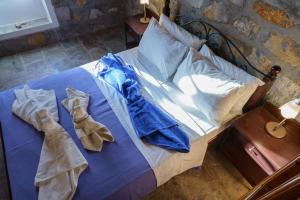 Ένα ή περισσότερα κρεβάτια σε δωμάτιο στο Βίλλα Μανδράκι