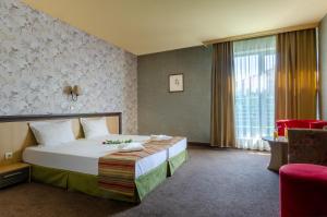 a hotel room with a bed and a window at Alliance Hotel in Plovdiv +35 photos