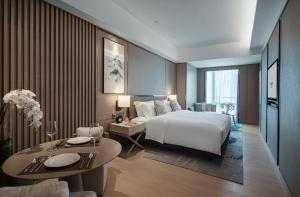 A bed or beds in a room at Fraser Residence Chengdu