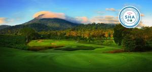a painting of a golf course with a mountain at Chatrium Golf Resort Soi Dao Chanthaburi in Ban Thap Sai