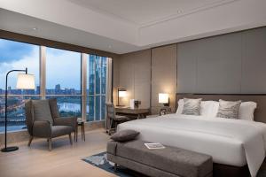 A bed or beds in a room at Fraser Residence Chengdu