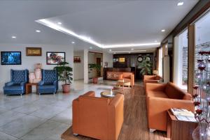 a lobby with couches and chairs in a building at Ekant Retreat Resort in Chail