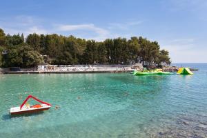 two boats are in the water at a beach at Apartment Soni A4 in Krk