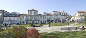 a large building with a park in front of it at Casinhas Da Vila in Monção