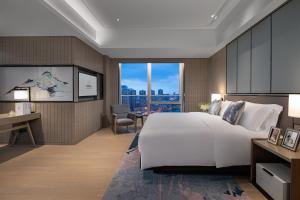 A bed or beds in a room at Fraser Residence Chengdu