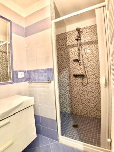 a bathroom with a shower with a glass door at Terrazza sul mare Pisciotta - Palinuro in Pisciotta