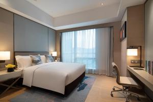 A bed or beds in a room at Fraser Residence Chengdu