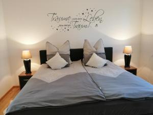 a bedroom with a large bed with two lamps at Traumzeit-Ferienwohnung in Eisenach