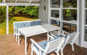 a white table and chairs on a porch at 2 Bedroom Lovely Home In Sæby in Sæby +6 photos