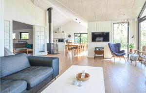 a living room with a couch and a table at Cozy Home In Vinderup With House Sea View in Vinderup