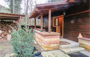 a house with a porch with a christmas tree in front of it at Gorgeous Home In Merzalben With Wifi in Merzalben +15 photos