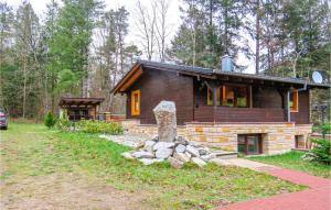 a log cabin with a stone monument in front of it at Nice Home In Merzalben With 2 Bedrooms And Wifi in Merzalben