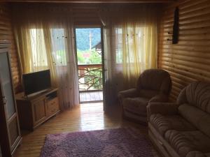 Televízia a/alebo spoločenská miestnosť v ubytovaní Guest House Arnika