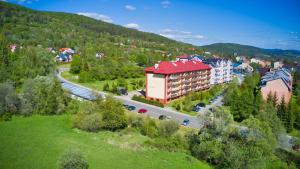 an aerial view of a town with a building and a road at Apartament Bieszczadzkie Klimaty in Ustrzyki Dolne