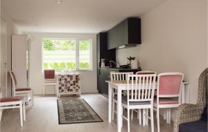 una cucina con tavolo, sedie e finestra di Beautiful Home In Søgne With Wifi a Søgne