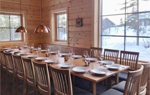a long wooden table in a room with windows at Stunning Home In Vemdalen With Sauna in Vemdalen