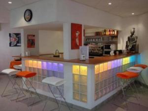 a kitchen with a bar with stools in it at Vanina Park in Corte