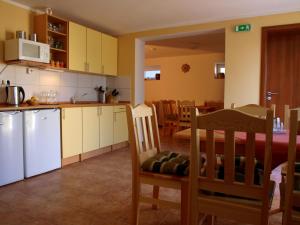 a kitchen with white appliances and a table and chairs at Penzion U Dvou lip in Drnholec