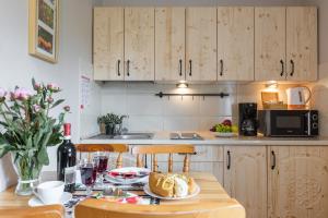 a kitchen with a table with a plate of food on it at Apartamenty Zakopane Krupówki in Zakopane