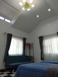 a bedroom with two beds and a ceiling fan at Pakdeehouse Homestay in Phra Nakhon Si Ayutthaya