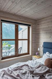 a bedroom with a bed and a large window at Vangsgaarden Gjestgiveri in Aurland